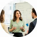Delissa Sedgeworth, operations adviser discussing a process board with colleagues